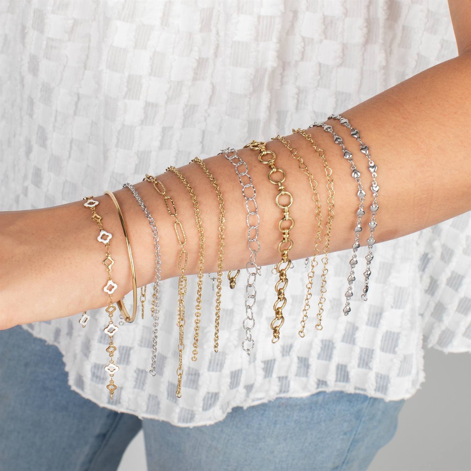 Layered permanent jewelry bracelets in gold and silver